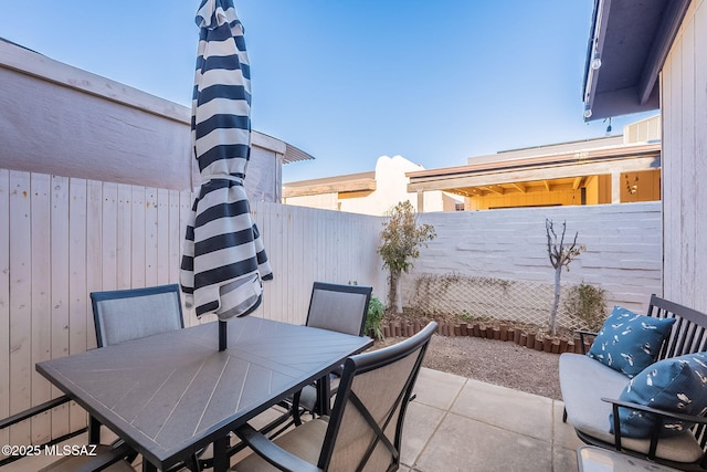 view of patio / terrace with outdoor dining space and a fenced backyard