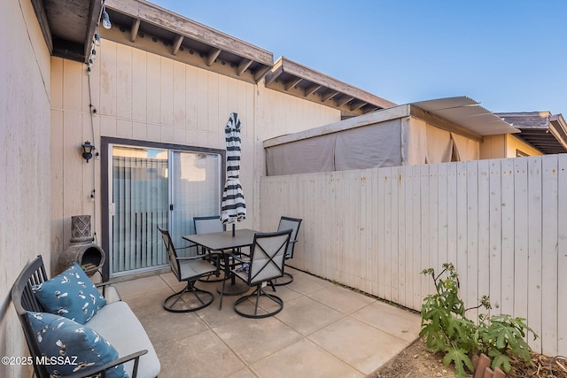 view of patio / terrace featuring fence and outdoor dining area