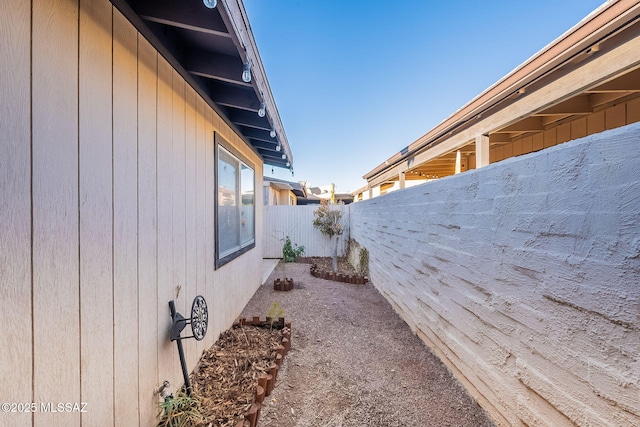 view of side of property with fence