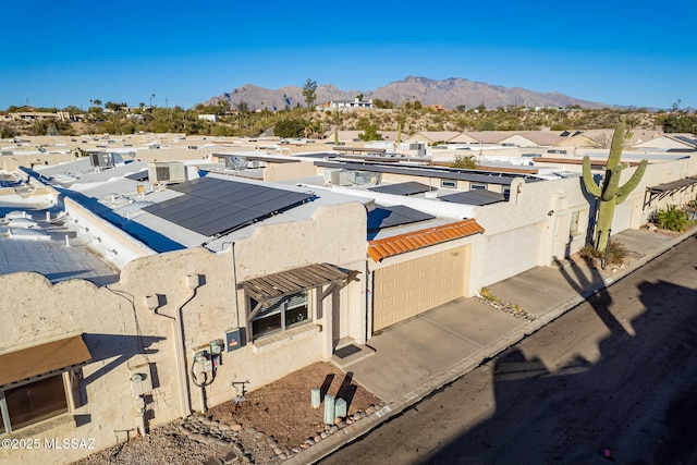 view of building exterior featuring a residential view and a mountain view