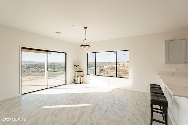 unfurnished living room with an inviting chandelier