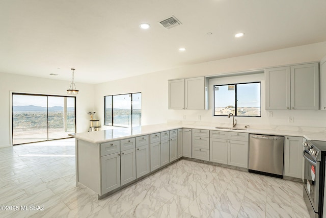 kitchen with pendant lighting, stainless steel appliances, sink, gray cabinets, and kitchen peninsula