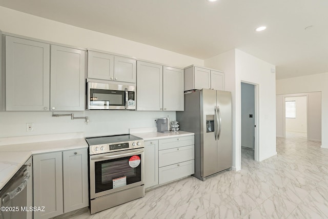 kitchen with gray cabinets and stainless steel appliances