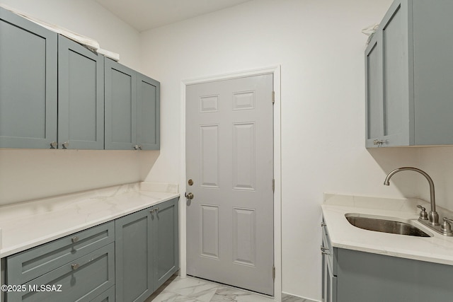 clothes washing area featuring sink