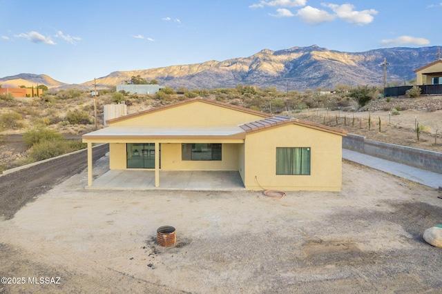 view of front of house featuring a patio area and a mountain view