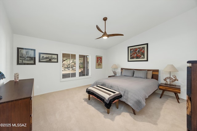 bedroom with ceiling fan, light carpet, and vaulted ceiling