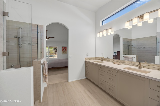 bathroom with vanity and a tile shower