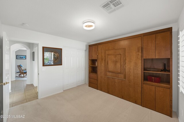 unfurnished bedroom with light carpet