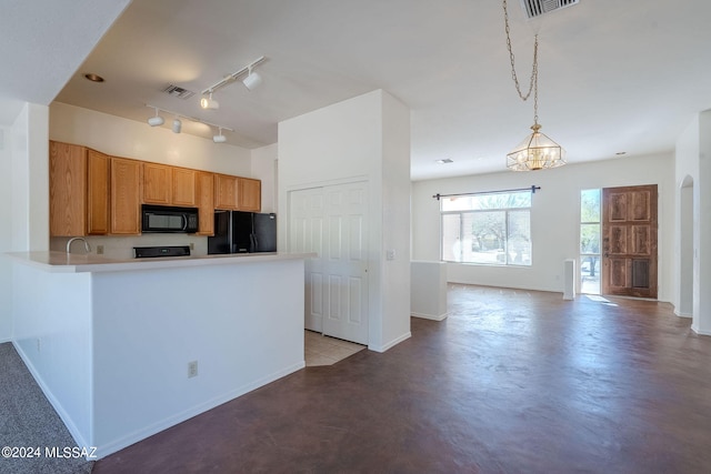 kitchen featuring an inviting chandelier, kitchen peninsula, black appliances, pendant lighting, and sink