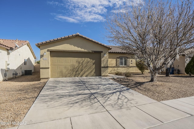 view of front of home featuring a garage and central AC