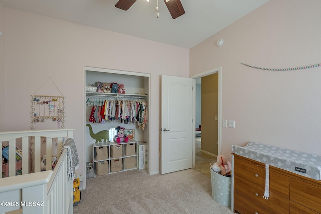 carpeted bedroom with ceiling fan and a closet