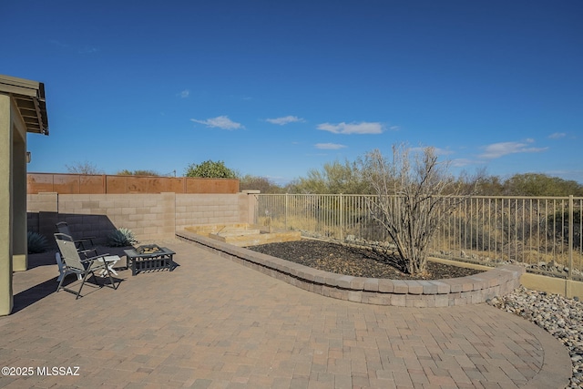 view of patio with an outdoor fire pit