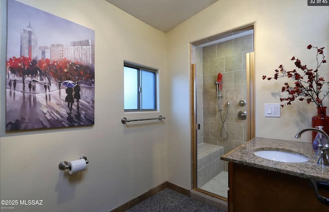 bathroom with a shower with door and vanity