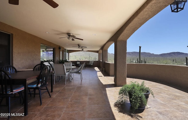 view of patio with a mountain view and ceiling fan