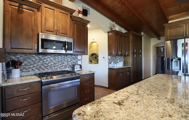 kitchen featuring light stone counters, wood ceiling, tasteful backsplash, lofted ceiling with beams, and stainless steel appliances