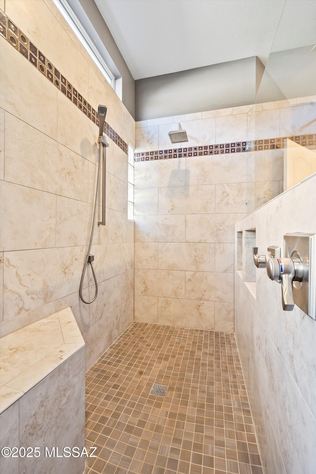 bathroom with tiled shower