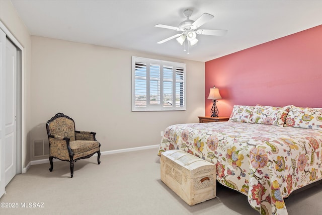 bedroom featuring light carpet, a closet, and ceiling fan
