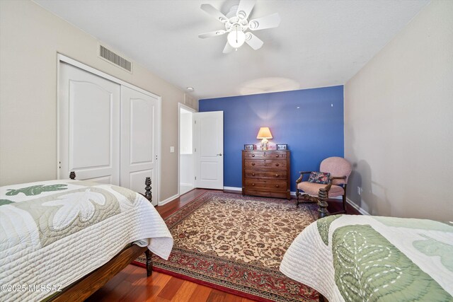 bedroom featuring hardwood / wood-style floors, ceiling fan, and a closet