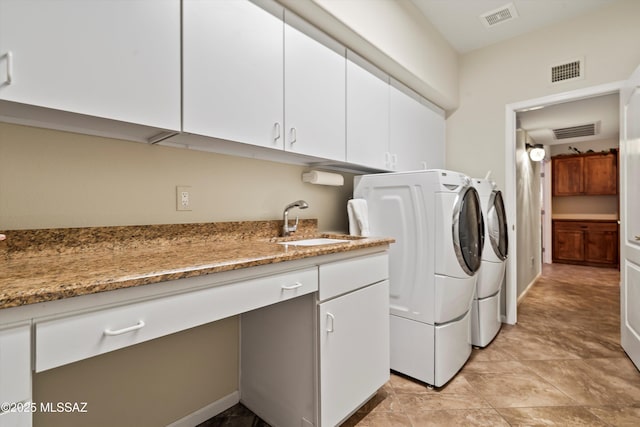 laundry area with cabinets, sink, and washer and clothes dryer
