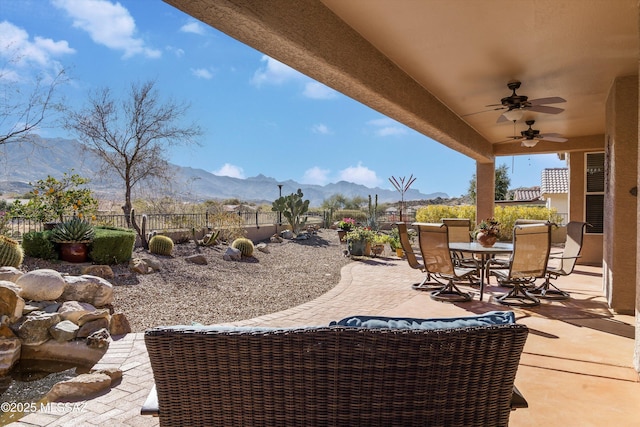 view of patio / terrace with a mountain view and ceiling fan