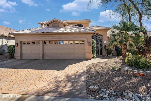 mediterranean / spanish house with a garage