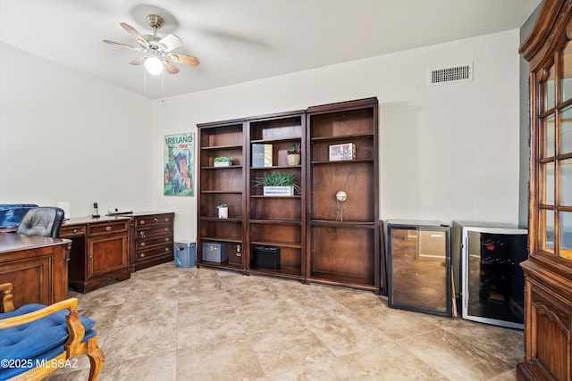 office area with ceiling fan and beverage cooler