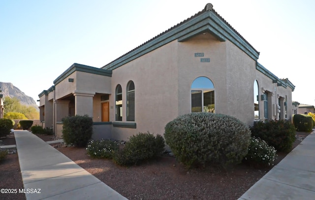 view of property exterior with a mountain view