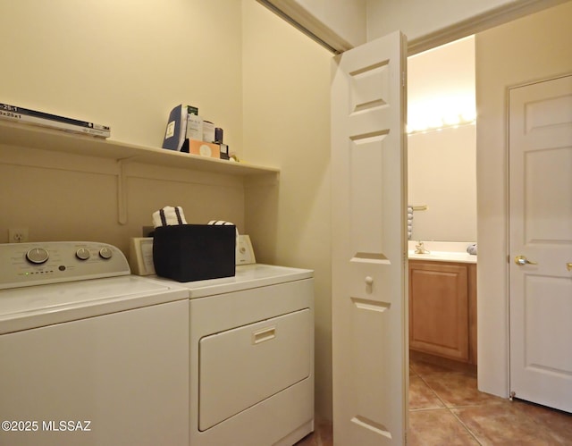 laundry area featuring washing machine and dryer and light tile patterned floors