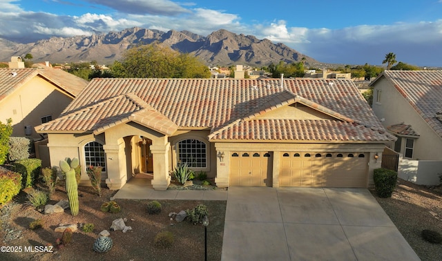 view of front of property featuring a garage and a mountain view