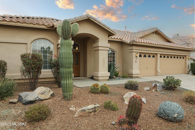 mediterranean / spanish-style home featuring a garage