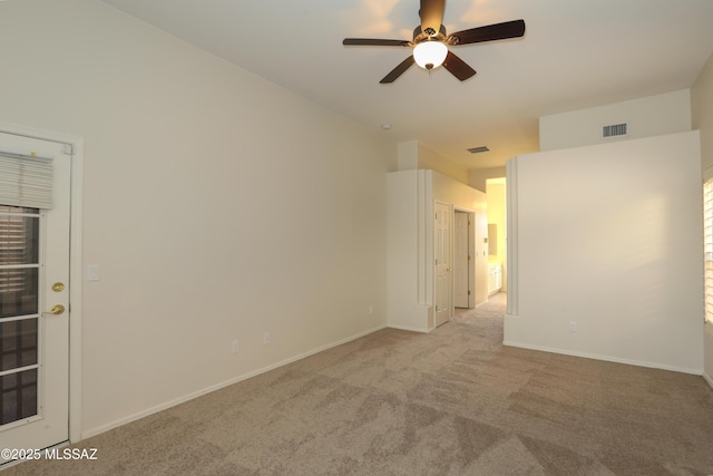 spare room with ceiling fan and light colored carpet