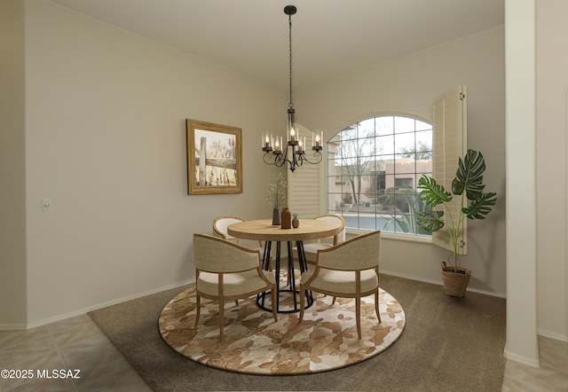 tiled dining room with an inviting chandelier