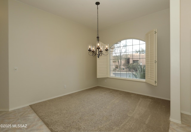 tiled empty room featuring a chandelier