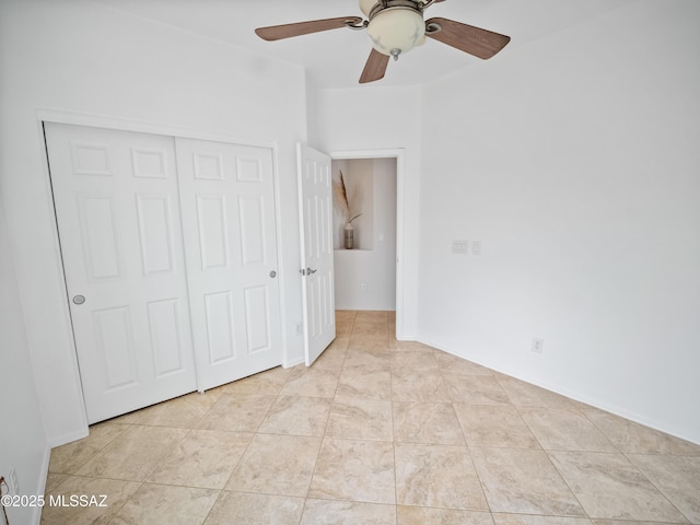 unfurnished bedroom featuring light tile patterned floors, a closet, and a ceiling fan