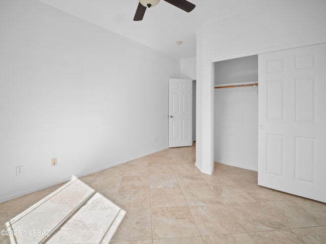 unfurnished bedroom with a ceiling fan and a closet