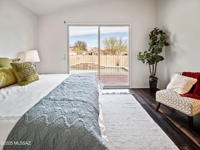 bedroom featuring access to exterior, lofted ceiling, and wood finished floors