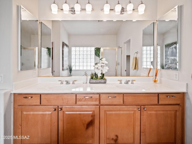 full bathroom with a garden tub, a sink, a shower stall, and double vanity