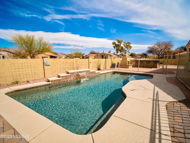 view of swimming pool featuring a patio area, a fenced backyard, and a fenced in pool