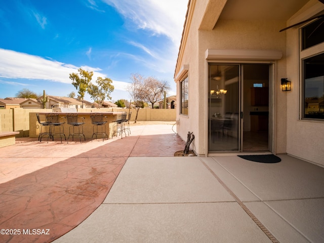 view of patio / terrace with fence and outdoor dry bar