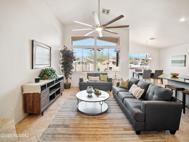 living area with visible vents, vaulted ceiling, and light tile patterned floors