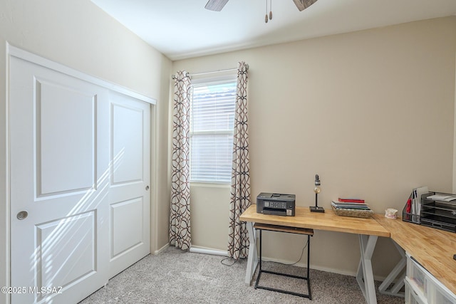 carpeted home office with ceiling fan