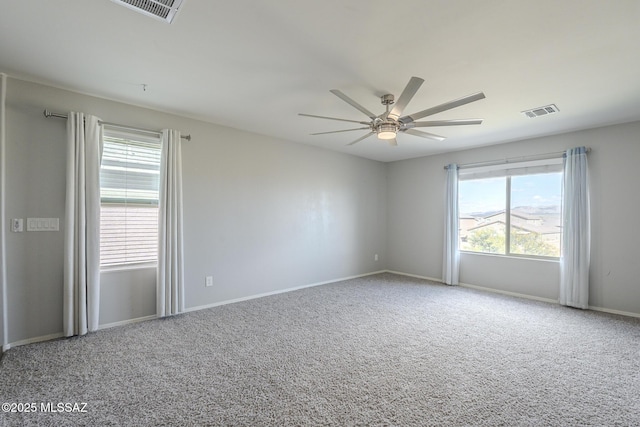 empty room featuring ceiling fan and carpet floors