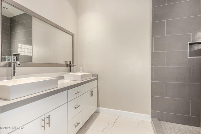 bathroom featuring vanity and tiled shower