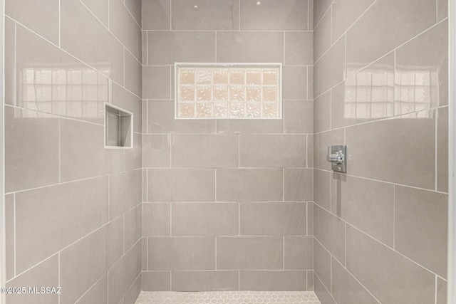 bathroom with tiled shower