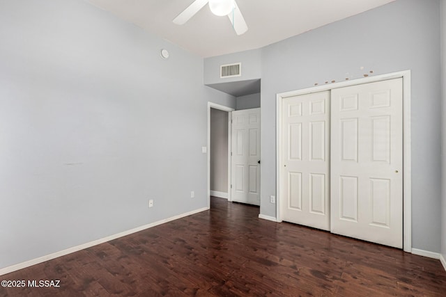 unfurnished bedroom featuring ceiling fan, a closet, and dark hardwood / wood-style floors