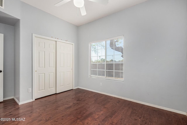 unfurnished bedroom with ceiling fan, a closet, and dark hardwood / wood-style floors