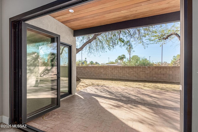 entryway featuring wood ceiling and a wealth of natural light