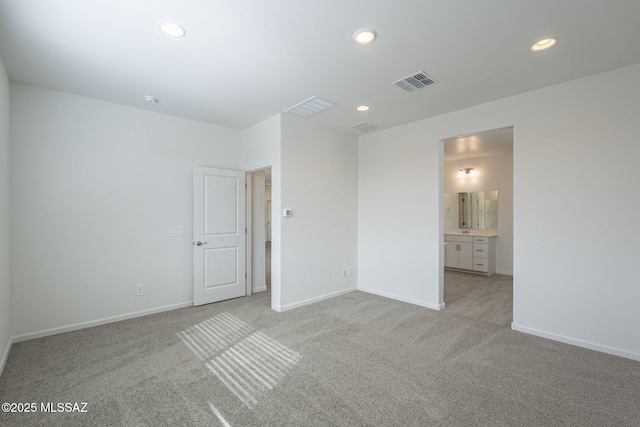 unfurnished room featuring light colored carpet