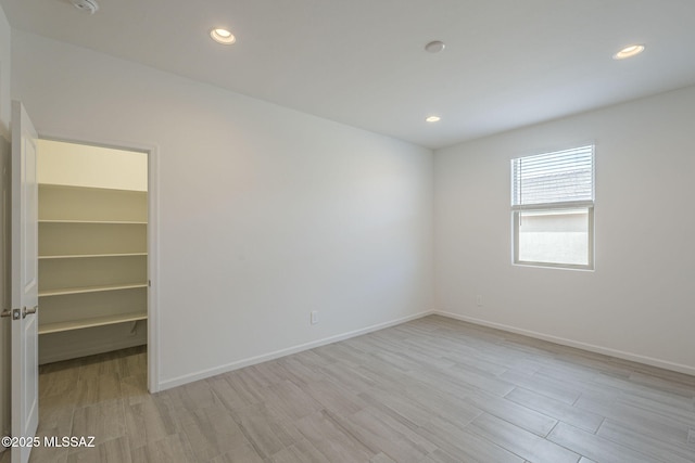 spare room with light hardwood / wood-style floors