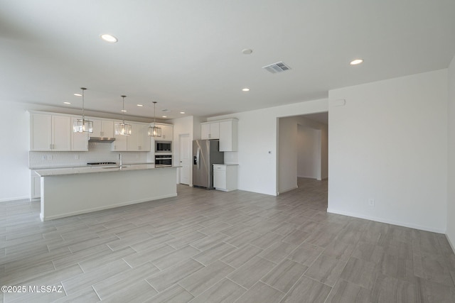 unfurnished living room featuring sink